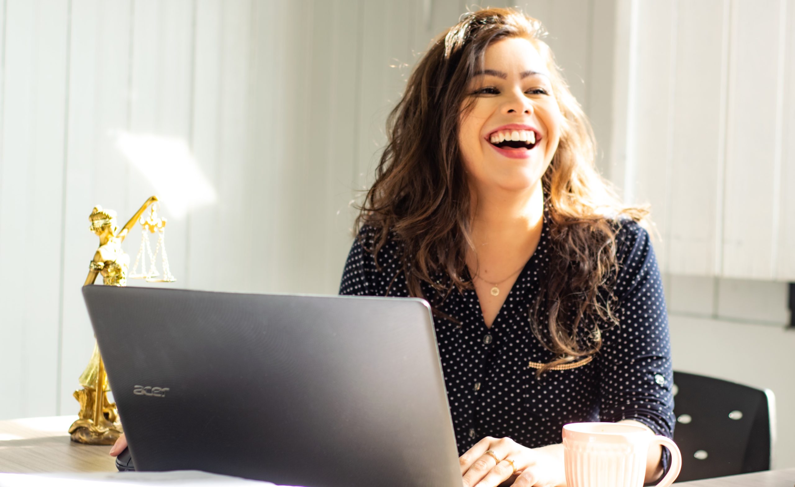 girl laughing at laptop